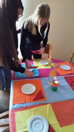 Uczennice Zespołu Szkół podczas warsztatów kulinarnych - ćwiczenia z nakrywania do stołu